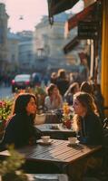 Candid capture of two young women enjoying a sunny afternoon conversation at an outdoor cafe setting serenity photo