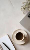 Minimalist workspace aesthetic featuring coffee laptop notebook and flowers promoting calm and productive atmosphere top view photo