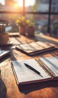 Aesthetic Workspace with Journal Open Pen and Morning Sunlight Inviting Productivity and Reflection photo