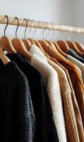 Closet showcase wooden hangers neatly displaying an array of diverse sweaters and jackets apparel collection ready photo