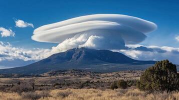 Unusual Saucer Cloud Suspended Above a Summer Summit photo