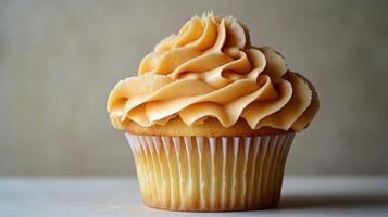 Vanilla cupcake with caramel frosting photo