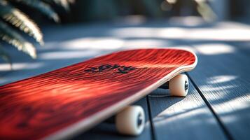 Red skateboard on wooden deck photo