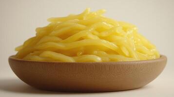 Pile of golden yellow noodles in a bowl photo