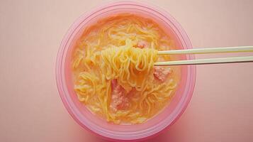 Instant noodles in a pink bowl photo