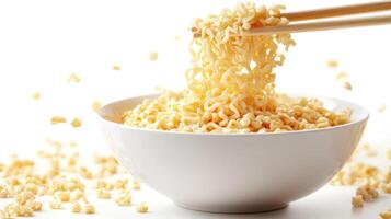 Instant noodles in a bowl, being picked up with chopsticks photo