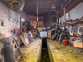 An auto mechanic workshop packed with tools, wires, and metal parts shows real industrial grit and functional chaos photo