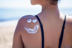 Enjoying a playful Sunscreen application on your face while relaxing on the shoulder at the beach photo