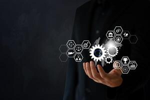 The Business man use hand to hold digital and techology icon floating on screen photo