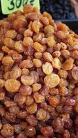 Golden dried fruits at local market in sunny afternoon video