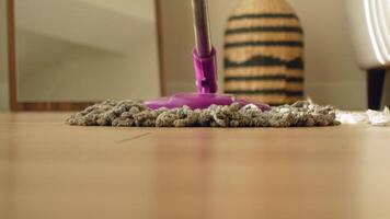 Cleaning hardwood floor with a mop and reusable pad video