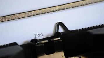 Typing the expression Don't Give Up with a manual typewriter video
