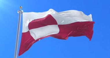 Flag of Greenland waving at wind with blue sky in slow, loop video