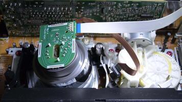 Vhs mechanism helical head gyrating and reading a videotape video