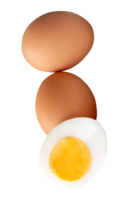 Brown chicken eggs and cooked or boiled chicken egg with egg yolk in half in small pile isolated with clipping path in file format png