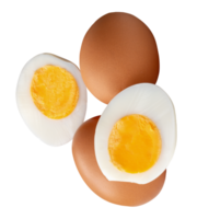 Top view of two raw chicken eggs and peeled cooked or boiled egg with egg yolk in two halves in stack isolated with clipping path in file format png