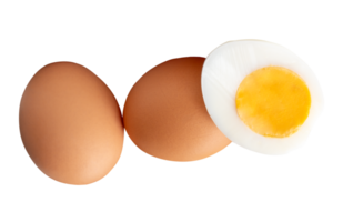 Raw brown chicken eggs and cooked or boiled chicken egg with egg yolk in half in small pile isolated with clipping path in file format png