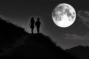 Two people walking up a hill with a full moon in the background photo