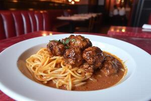 A plate of spaghetti and meatballs on a table photo