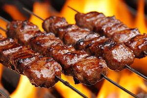Beef kebabs on a grill with flames photo