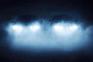 Two cars are seen in the dark with fog photo