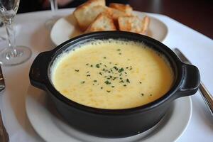 A bowl of soup with bread on a plate photo