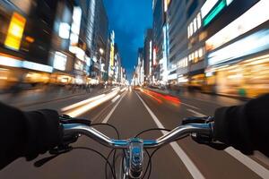 A person riding a bicycle down a busy street at night photo
