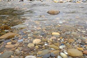 A river with rocks and pebbles in it photo