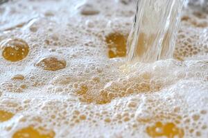 A close up of a glass of beer being poured photo