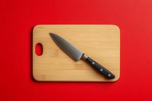 A knife on a cutting board on a red background photo