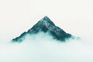 A mountain is covered in fog and clouds photo