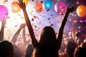 A crowd of people at a party with balloons and confetti photo