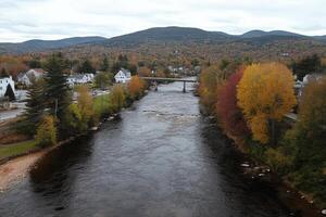 A river flowing through a town with houses on either side photo
