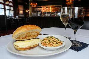 A plate with a sandwich and a glass of wine photo