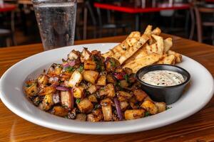 A plate of food with fries and dip on a table photo