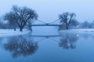 A bridge over a river in a foggy day photo