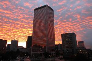 A tall building with a sky filled with clouds photo