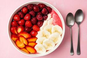A bowl of strawberries, bananas and strawberries photo