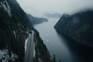 A boat is traveling down a river in the middle of a mountain photo