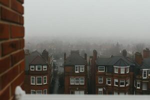 A view of a foggy city from a window photo