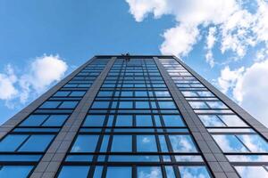 A tall building with windows and a sky background photo