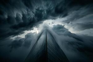 A skyscraper is seen in the sky with dark clouds photo