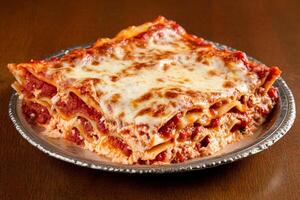 A plate of lasagna on a table photo