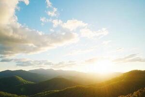 The sun is setting over the mountains in this photo