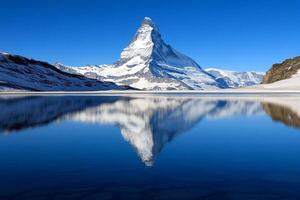 A mountain with a reflection in a lake photo