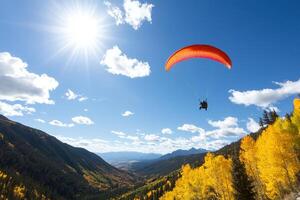 A person flying a parachute over a mountain range photo