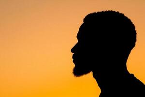 A silhouette of a man with a beard photo