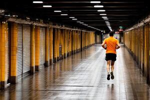 A man running in an empty hallway photo