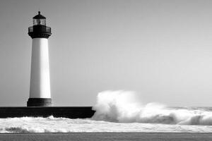 A black and white photo of a lighthouse with waves crashing into it