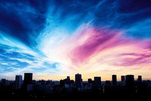 A colorful sky with a city in the background photo